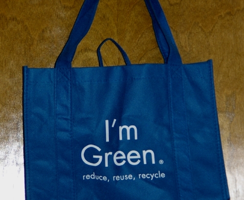 A BLUE fabric shopping bag with emblazoned the trendy caption, I'm Green. reduce reuse recycle